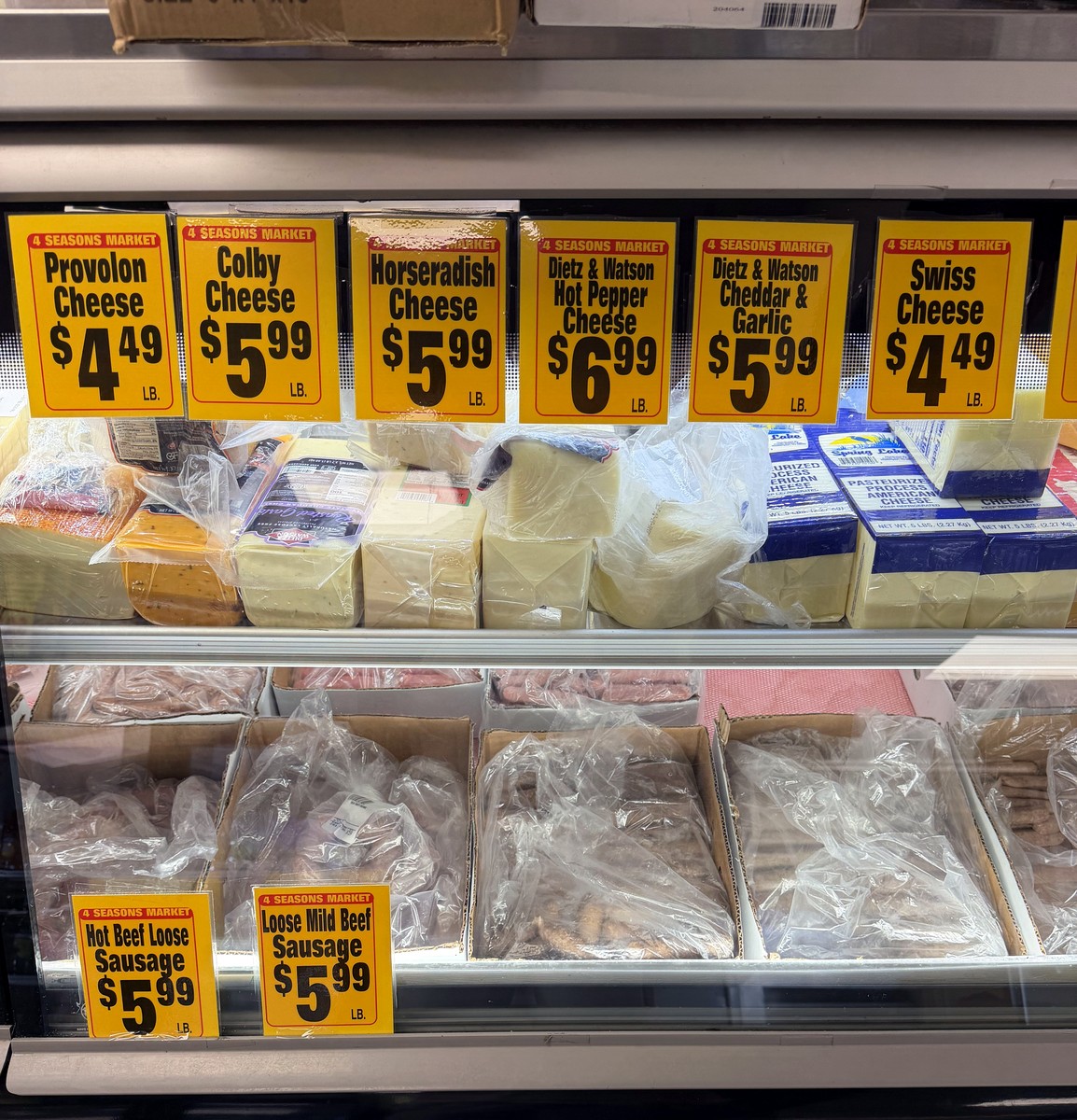 Deli case with cheeses and sausages